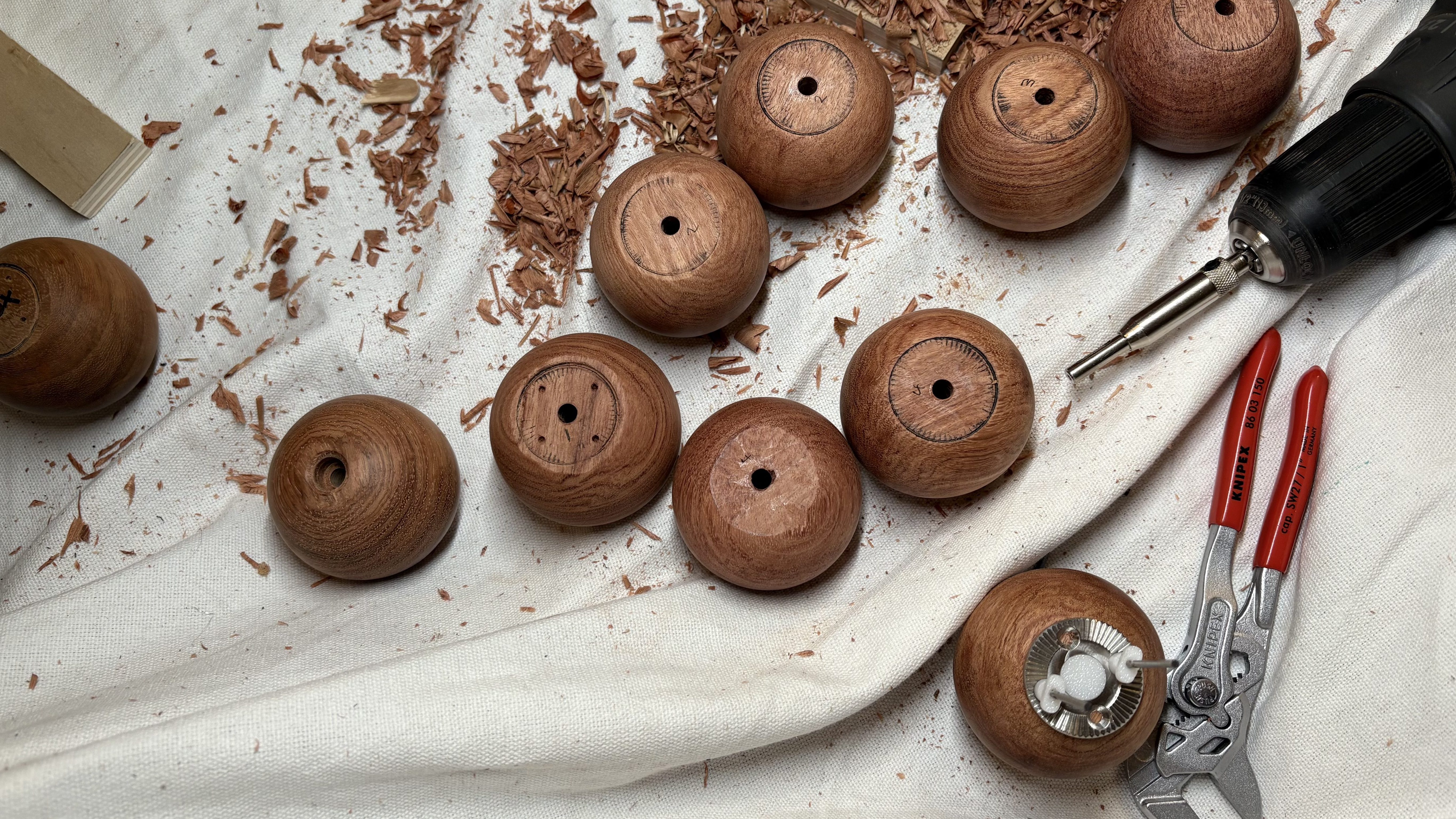 Solid hardwood rosewood wooden ball camera handle with stainless steel hardware being made.